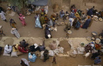 Looking down on traders  customers and stalls at busy rural market.