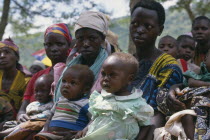 Women listening to nutrition advice given to mothers with vulnerable babies at food distribution in refugee camp on the Rwandan border.