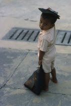 Portrait of young child standing on pavement.Burma Rangoon