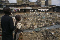 Children in squalid and dangerous slum without sanitation.