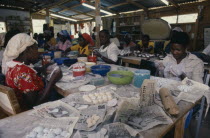 Female workforce in factory producing bead jewellery for export.