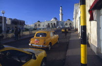 Streetscene with mosque and taxis.