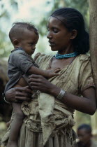 Three quarter Portrait of young mother holding child.