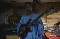Woman playing electric guitar. Zaire