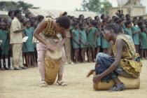 African women drummers with group of schoolchildren listening behind.Zaire Congo