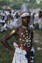 Sri Lanka, Kandy, Portrait of young man dressed for Kandy Esala Perahera, Procession to honour sacred tooth ehshrined in the Dalada Maligawa Temple of the Tooth.