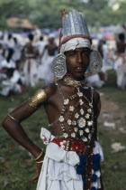 Sri Lanka, Kandy, Portrait of young man dressed for Kandy Esala Perahera, Procession to honour sacred tooth ehshrined in the Dalada Maligawa Temple of the Tooth.