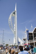 The Spinnaker Tower the tallest public viewing platforn in the UK at 170 metres on Gunwharf Quay with people on the waterfront area