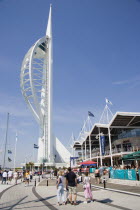 The Spinnaker Tower the tallest public viewing platforn in the UK at 170 metres on Gunwharf Quay with people on the waterfront area