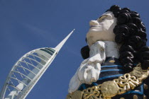 The Spinnaker Tower the tallest public viewing platforn in the UK at 170 metres on Gunwharf Quay with old ships bowspit figurehead in the foreground