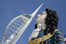 The Spinnaker Tower the tallest public viewing platforn in the UK at 170 metres on Gunwharf Quay with old ships bowspit figurehead in the foreground