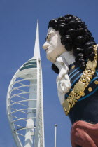 The Spinnaker Tower the tallest public viewing platforn in the UK at 170 metres on Gunwharf Quay with old ships bowspit figurehead in the foreground