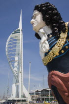The Spinnaker Tower the tallest public viewing platforn in the UK at 170 metres on Gunwharf Quay with old ships bowspit figurehead in the foreground