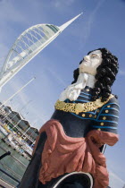 The Spinnaker Tower the tallest public viewing platforn in the UK at 170 metres on Gunwharf Quay with old ships bowspit figurehead in the foreground