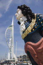 The Spinnaker Tower the tallest public viewing platforn in the UK at 170 metres on Gunwharf Quay with old ships bowspit figurehead in the foreground