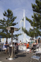 The Spinnaker Tower the tallest public viewing platforn in the UK at 170 metres on Gunwharf Quay with outdoor restaurant seating in the foreground