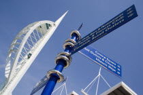 The Spinnaker Tower the tallest public viewing platforn in the UK at 170 metres on Gunwharf Quay with attractions signpost in the foreground
