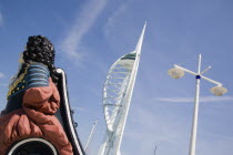 The Spinnaker Tower the tallest public viewing platforn in the UK at 170 metres on Gunwharf Quay with old ships bowsprit figurehead in the foreground