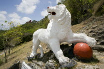 Imperial lion carved from coral rock by British soldiers serving at Gun Hill signal station with the station on the hill in the distance