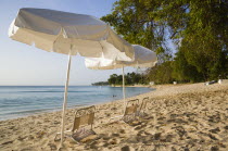 Sunshade umbrellas on Gibbes Bay beach in late afternoonBarbadian Beaches Resort Sand Sandy Seaside Shore Tourism West Indies Scenic Barbadian Beaches Resort Sand Sandy Seaside Shore Tourism West In...