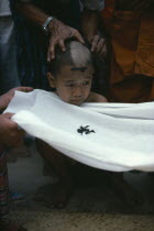 Initiate monk during ritual head shaving.