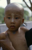 Initiate monk after ritual head shaving. Burma