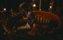 Musician playing circle of drums. Burma