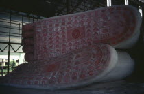 Giant reclining Buddha figure representing his death or parinirvana.  Detail of soles of feet. Burma