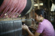 Young woman working in textile factory.