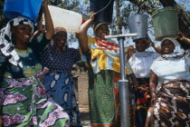 Women collecting water from well.