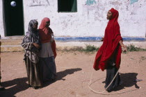 Girls playing skipping games with rope at Dr Ayub Primary School.African Eastern Africa Kids Learning Lessons Somalian Soomaliya Teaching