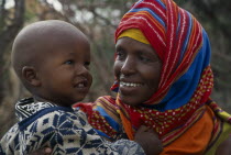 Portrait of mother wearing colourful headscarf holding and looking at her childColorful African Eastern Africa Kids Mum Somalian Soomaliya Children