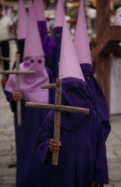 Penitents wearing purple purple robes and hoods during Easter celebrations.