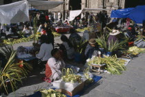 Women selling woven palm baskets and palm fronds outside San Francisco church for Palm Sunday.