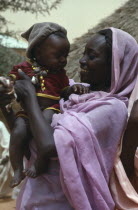 Nomadic African Arab woman holding baby.