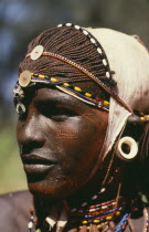 Portrait of Samburu warrior wearing ochre body paint and ivory ear plug.