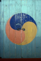Door of Buddhist temple painted with Taegukki symbol representing Korea as equal amongst nations.