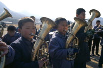 Juche ideology.  Pyongsan County band encouraging workers as they repair flood dykes.