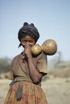 Portrait of laughing Galla girl holding gourds.Majority ethnic group. Pastoral  oromo speaking and largely muslim Moslem