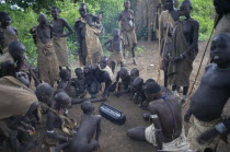 Mursi tribe gathering around cassette player.Pastoral tribe aka Murzu