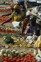 Female vendors with displays of vegetables and chillies at the market