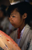 Portrait of young girl dressed as shrine maiden during Samurai Festival.