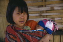 Lahu girl carrying baby in sling across her front.Musoe
