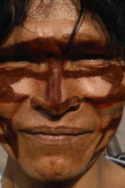 Portrait of Shuar Indian man with painted face.