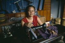 Female dressmaker at her sewing machine.