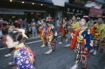Festival procession with young girls wearing traditional kimonos during the July Gion MatsuriFestival