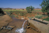 Ground water irrigating dry field on hilltop