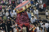 Huge firecracker  being carried through the street at the Firecracker Festival during Tet New Year