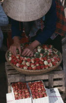 Woman selling strawberries in a market