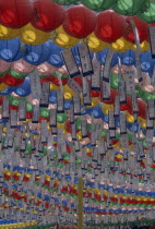 Jogyesa Temple.  Canopy of paper lanterns and prayer streamers hung to celebrate the birthday of Buddha.